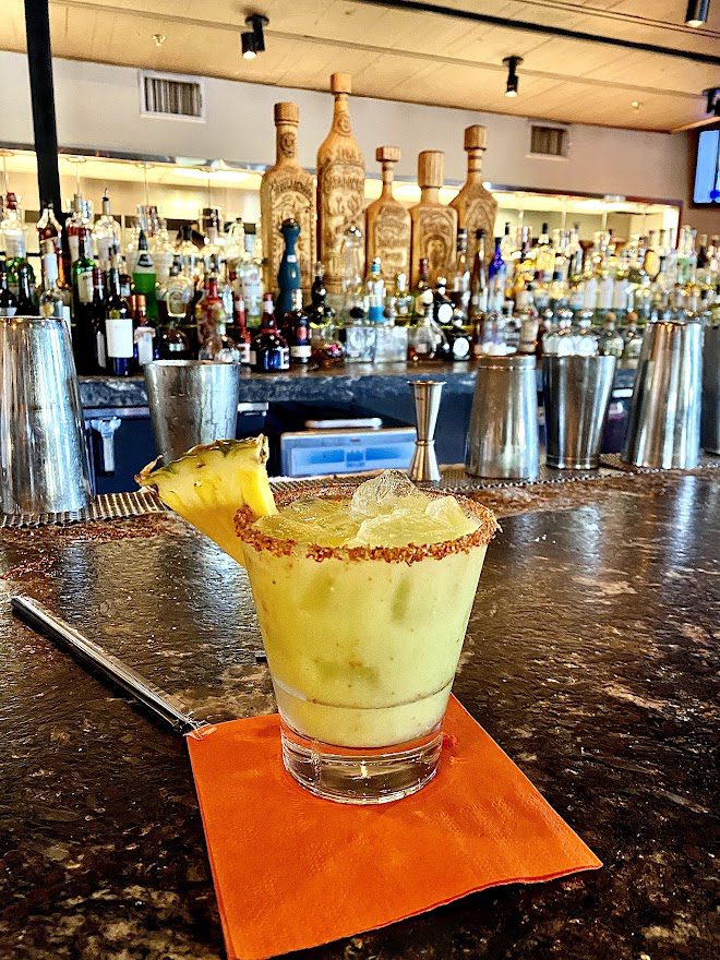 avocado margarita sitting on a bar in dallas