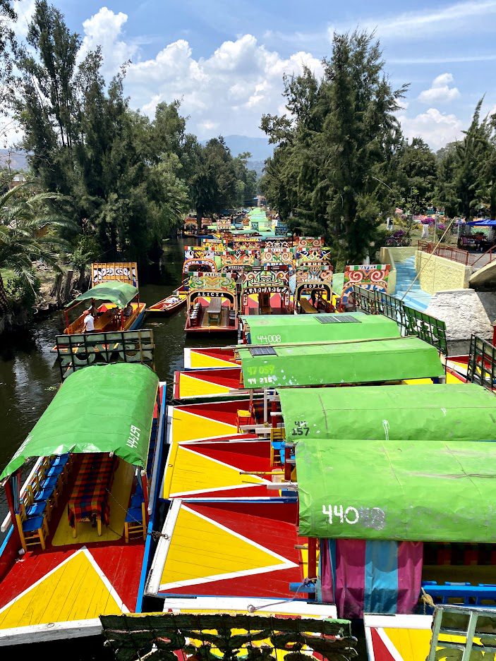 view of colorful boats from xochimilco in mexico city