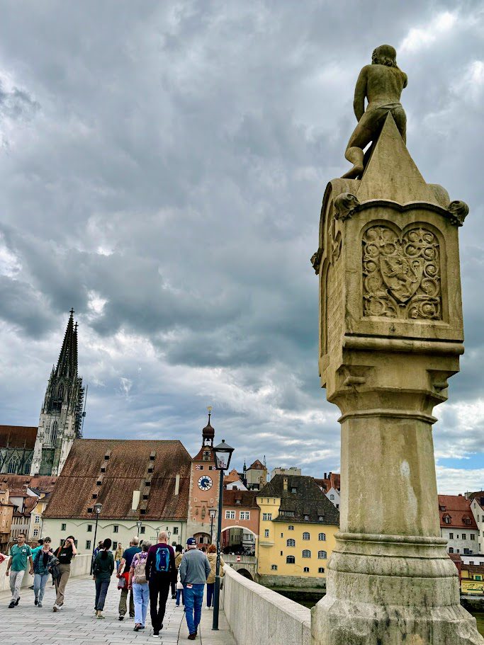 statue on the steinerne brucke stone bridge in regensburg germany